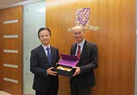 Prof. Fok Tai-fai (right), Pro-Vice Chancellor of CUHK presents a souvenir to Prof. Zhong Zhihua, President of TJU